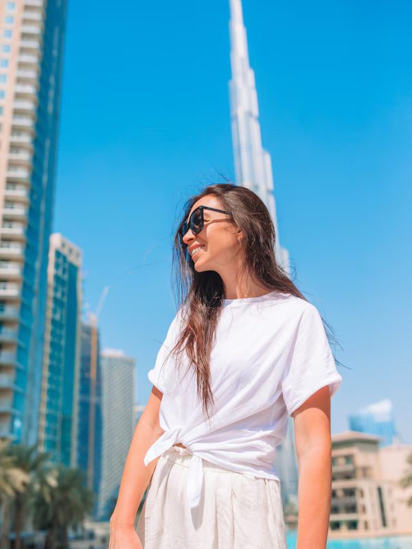 happy-woman-walking-dubai-with-burj-khalifa-skyscraper-background_109800-12871